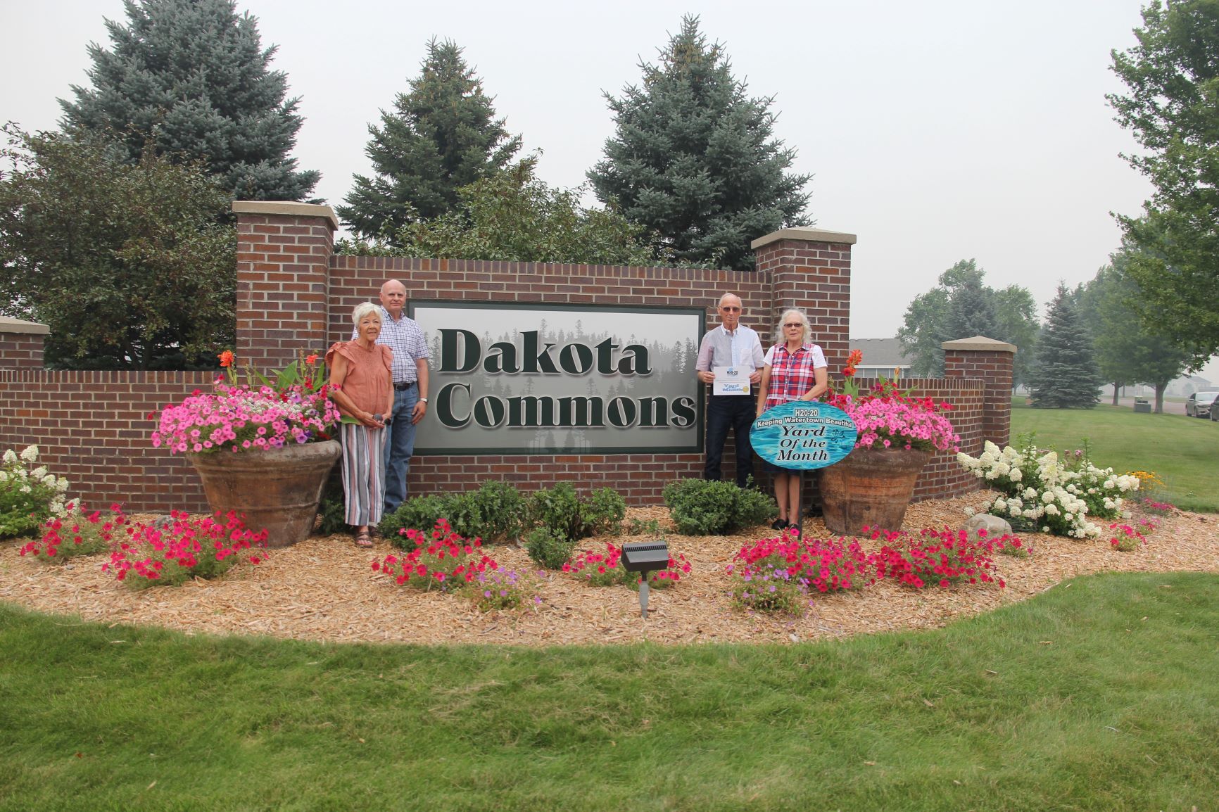 BUSINESS - Dakota Commons Twinhome Owners Association on 19th St NE. L to R - Linda Williams, Doug Harrington, Curt Kost (President), Jo Gardner.JPG